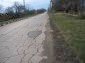 Asphalt road near a plot